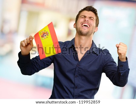 Man holding a flag and cheering, indoor
