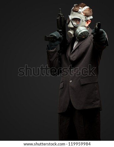 Businessman Holding Gun With Gas Mask against a black background