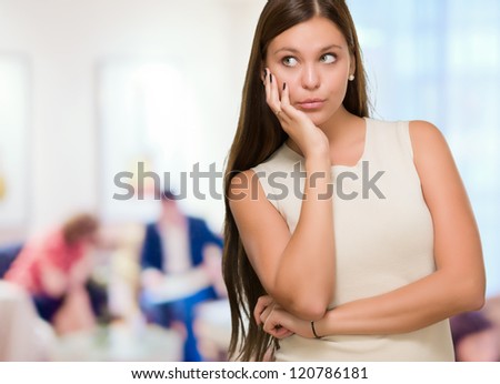 Portrait Of A Young Confused Woman against an abstract background