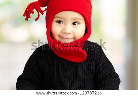 Portrait Of Baby Boy Wearing Warm Clothing at his home, indoor