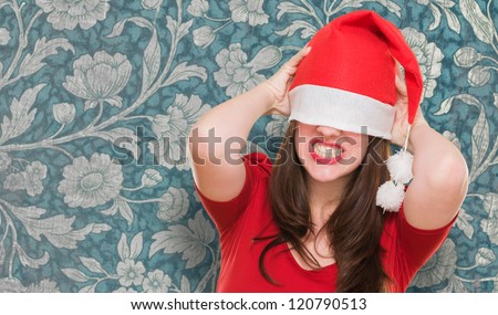 angry woman with a christmas hat covering her eyes against a vintage background