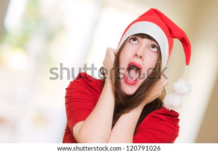 stressed woman wearing a christmas hat, indoor