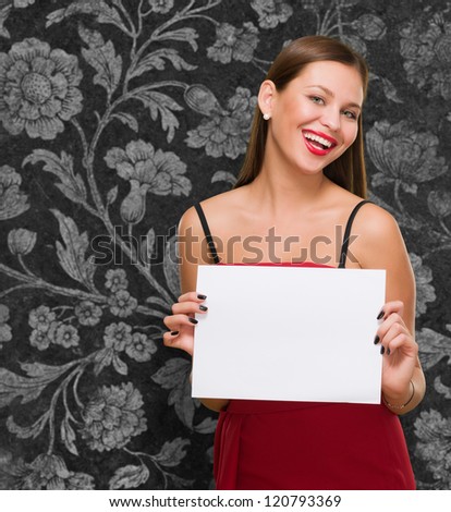 Happy Young Woman Holding Blank Placard against a vintage background