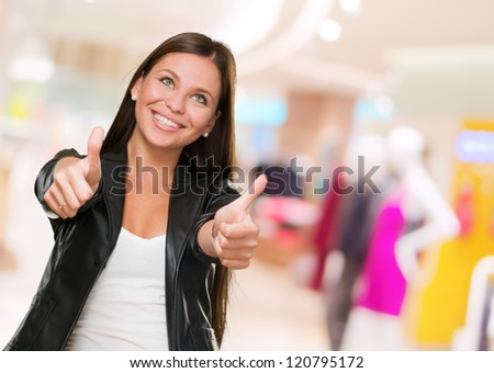 Young Happy Woman With Thumbs Up at a fashion store