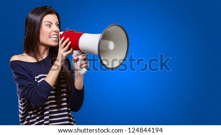 Portrait Of A Female With Megaphone On Blue Background
