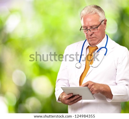 Portrait Of A Male Doctor Holding A Tab, Outdoor