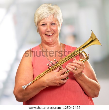 Senior Woman Blowing Her Trumpet, Indoor