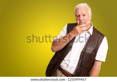 Portrait Of Sad Old Man On Color Background