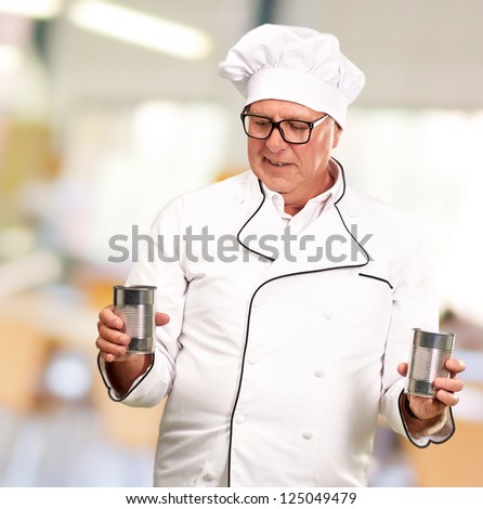 Portrait Of A Chef Holding Tin Cans, Indoor