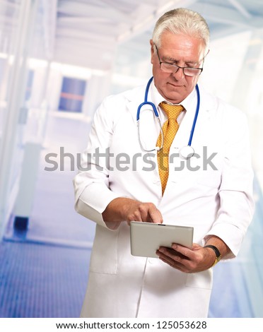 Senior Doctor Using Digital Tablet, Indoors