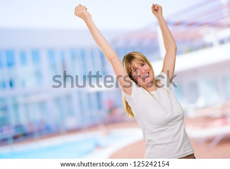 Happy Woman Cheering near a swimming pool