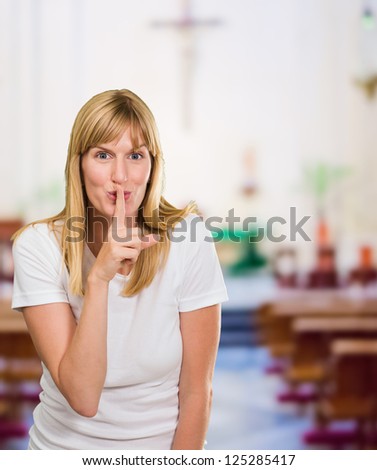 Woman With Finger On Lip at a church