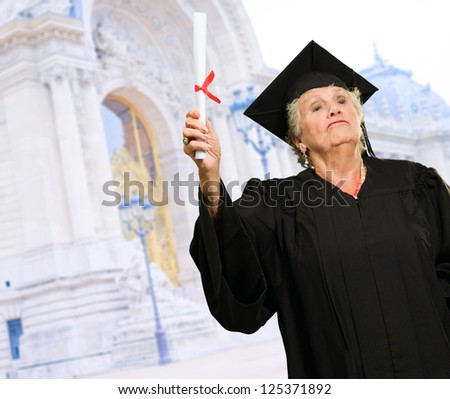 Senior Woman Holding Graduation Certificate, Outdoors