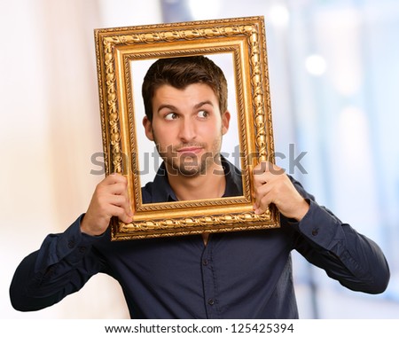 Young Man Holding Picture Frame, Indoor