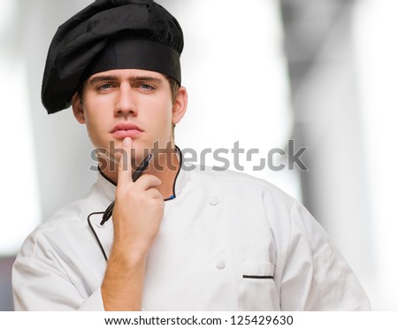 Young Chef Thinking against an abstract background