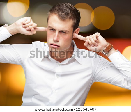 Portrait Of Young Man With Finger In His Ear, Outdoor