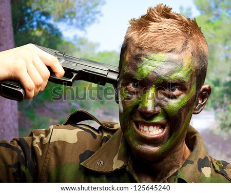 Soldier Putting Gunshot On Head at a park