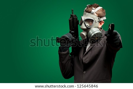 Businessman Holding Gun With Gas Mask against a dark green background