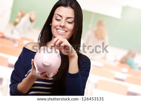 Portrait Of A Young Girl Holding A Piggy Bank, Indoor