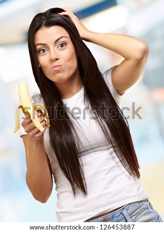 A Young Woman Eating A Banana, Indoor