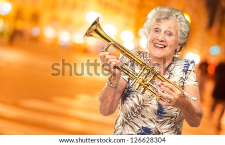 Portrait Of A Senior Woman Holding A Trumpet, Outdoor