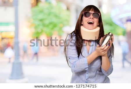 Woman Wearing Neck brace Holding A Shaker, Outdoor
