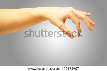 Human Hand Picking On Gray Background