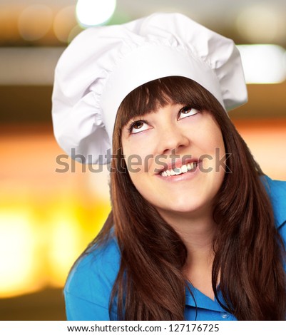 portrait of a female chef looking up, outdoor
