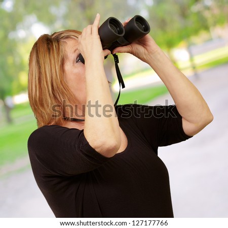 Women looking through binoculars, outdoor