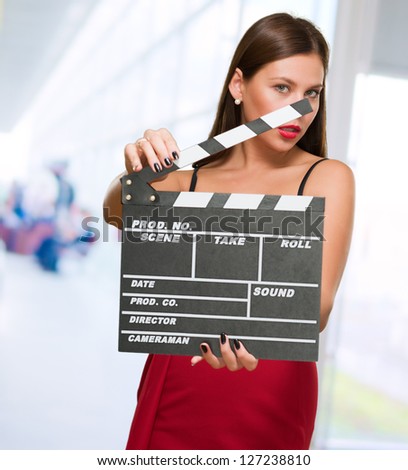 Woman In A Red Dress Holding Clapper Board, indoor