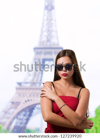 Portrait Of Young Fashioned Woman in front of the eiffel tower