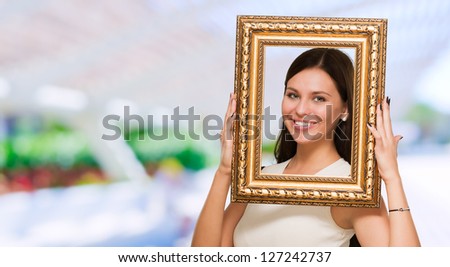 Portrait Of A Young Girl Holding Frame, outdoor