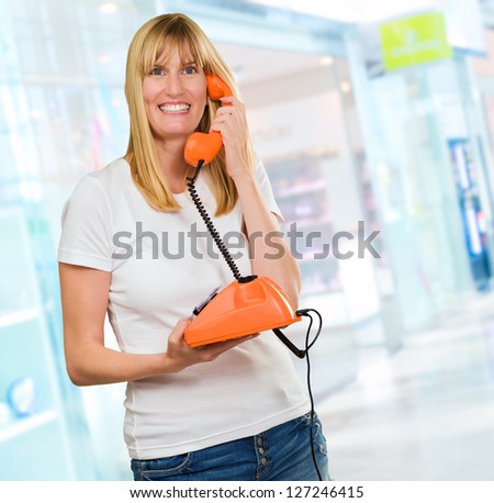 Happy Woman Holding Telephone at the mall