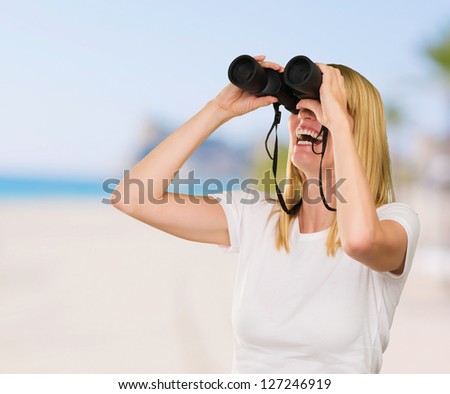Woman Looking Through Binoculars at a beach