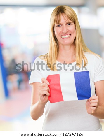 woman holding a french flag, indoor
