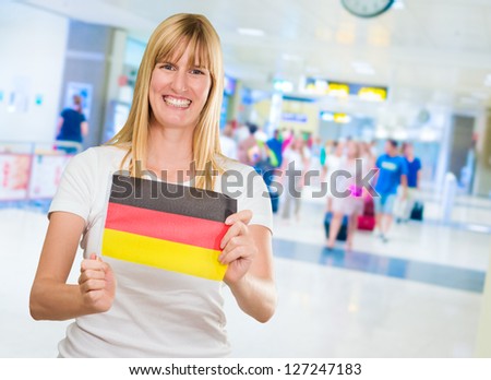 woman holding a german flag in an airport