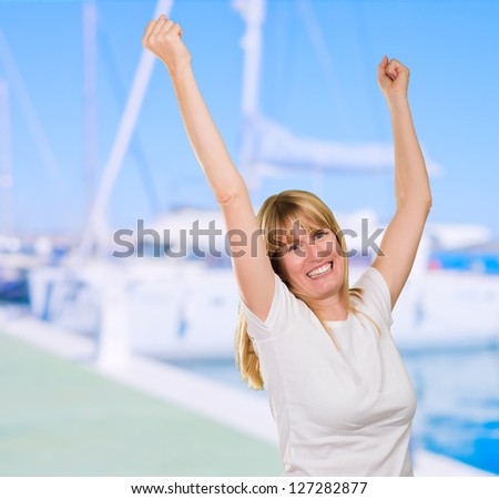 Happy Woman Cheering at a port full of boats