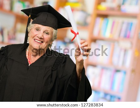 Senior Woman Holding Graduation Certificate, Indoors