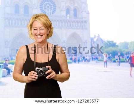 Mature Woman Holding Camera, Outdoors