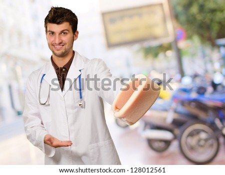 Young Doctor Holding Neck Brace, Outdoor