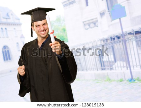 Portrait Of Young Graduation Man Holding Certificate, Outdoor