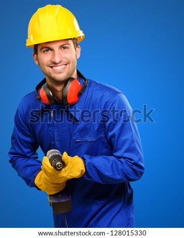 Happy Engineer With Drill Machine Isolated On Blue Background