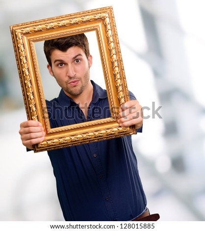 Young Man Holding Picture Frame, Indoor