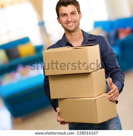 Young Man Holding Card Boxes, Indoors
