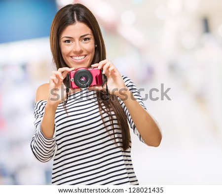Portrait Of A Young Woman Holding Camera, indoor