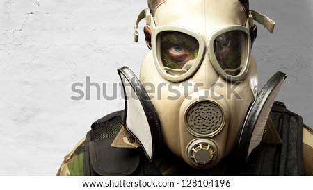 Close-up Of Soldier Wearing Mask against a concrete background