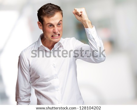 Portrait Of Angry Young Man Clenching His Fist, Outdoor