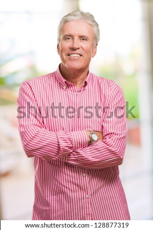 Portrait Of Mature Man Folding Arms against an abstract background