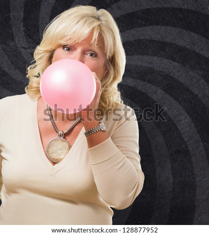 Woman Blowing Bubble Gum against a spiral background