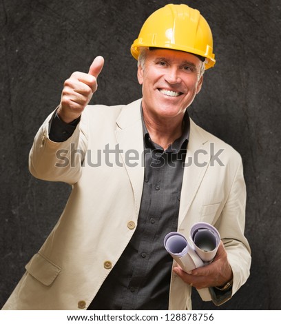 Happy Architect Man Showing Thumb Up Sign against a grunge background